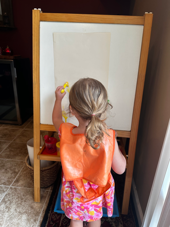 A child creating at an easel